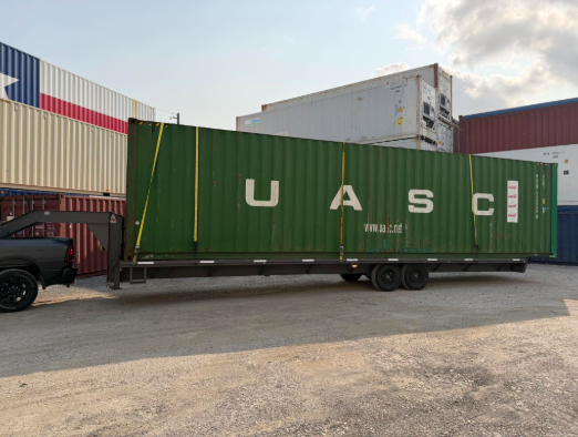 green storage container loaded on trailer